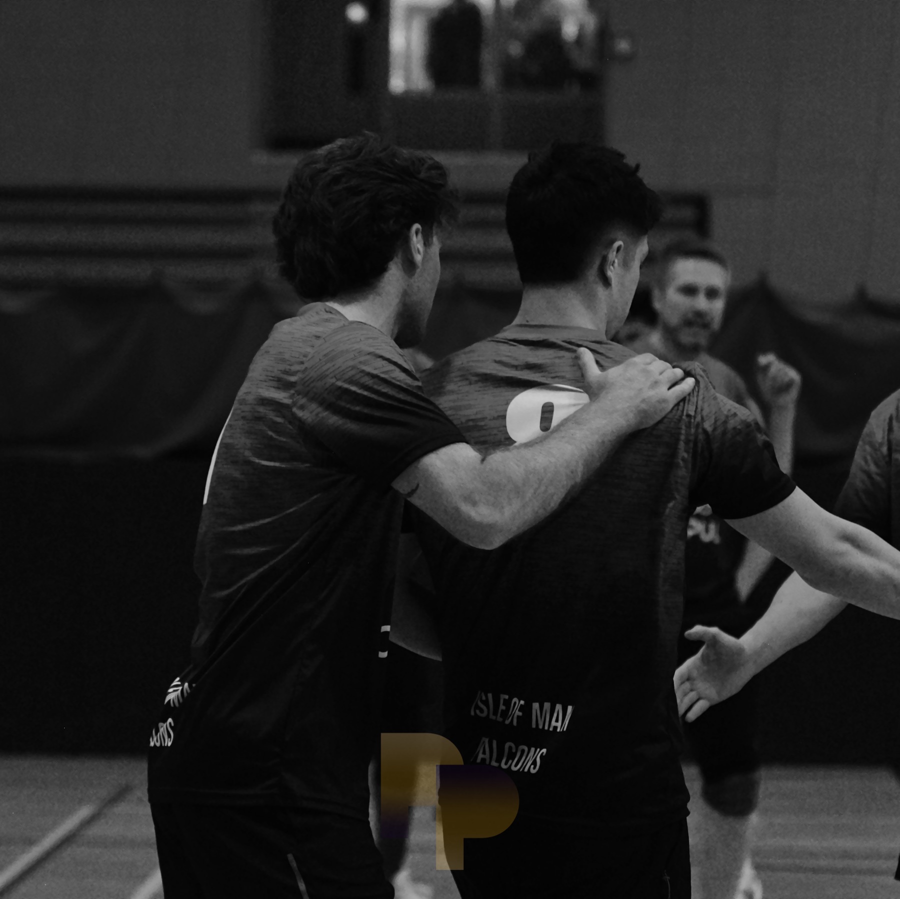 Two teammates embracing in celebration, black and white